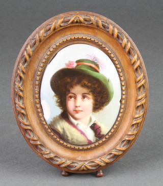 A 19th Century German porcelain oval plaque decorated with a figure of a young boy 3 1/2" x 2 1/2", framed 