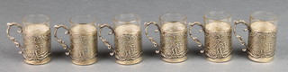 A set of 6 Edwardian repousse silver tots with glass liners decorated with figures in rural landscapes Sheffield 1903