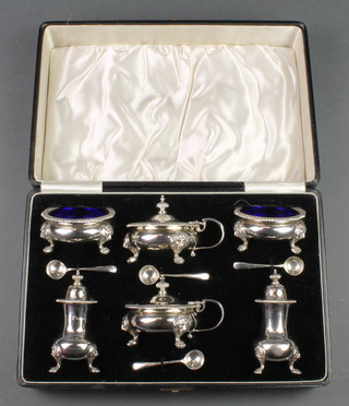 A silver 6 piece cased condiment set with gadrooned rims, lion knees and paw feet, comprising 2 salts, 2 peppers, 2 mustards and 4 spoons, Birmingham 1939 and 1940, 740 grams 