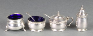 A silver 3 piece condiment with Arts & Crafts style decoration, Birmingham 1913 together with a silver mustard and spoon, 130 grams