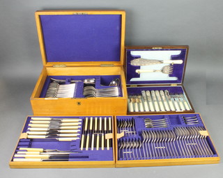 A part canteen of silver plated cutlery for 12 contained in a light oak canteen together with a mahogany canteen of fish eaters for 6 