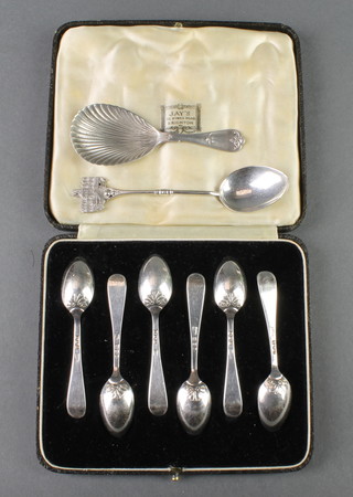 A cased set of 6 silver coffee spoons with scroll backs, London 1938, an Edwardian silver caddy spoon with shell bowl and fancy handle Chester 1906 and a silver souvenir spoon, 82 grams