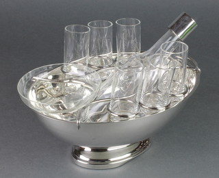 A Continental silver plated bowl containing a ditto bottle, 6 tots and a glass bowl 