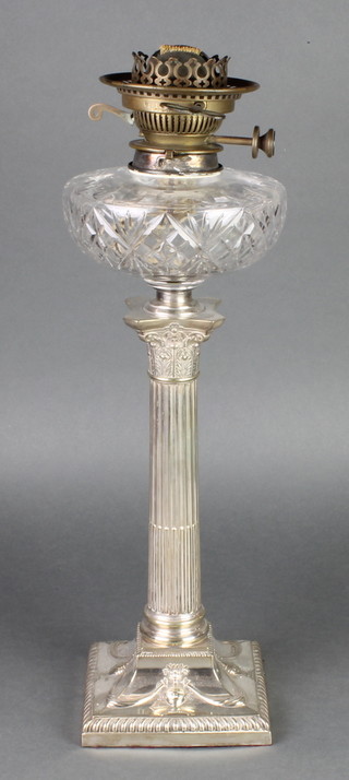 An Edwardian silver plated mounted table lamp with Corinthian column base and glass reservoir 19" together with a silver plated 2 handled tray 23" 