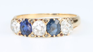 An 18ct yellow gold sapphire and diamond ring, size N