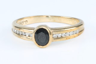 A 9ct yellow gold sapphire and diamond ring, size K
