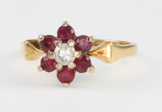 An 18ct yellow gold ruby and diamond cluster ring size G