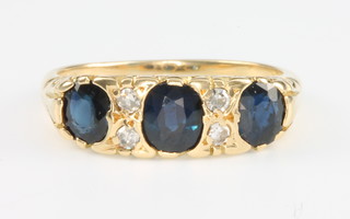 An 18ct yellow gold sapphire and diamond ring size N