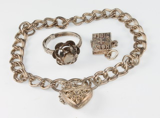 A silver charm bracelet and a ditto ring 