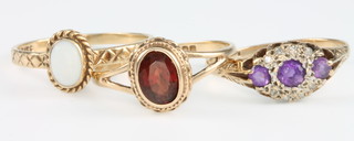 A 9ct yellow gold garnet ring size O, a 9ct yellow gold opal ring size N and a 9ct yellow gold amethyst ring size L 1/2 