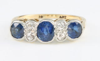 An 18ct yellow gold sapphire and diamond ring with rub-over setting, size M
