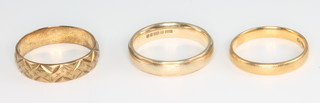 A 22ct gold wedding band size L - 2 grams, 2 9ct yellow gold ditto size N and P - 6 grams