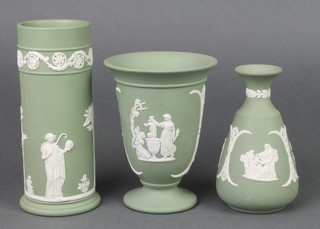 A Wedgwood green Jasperware cylindrical vase decorated with figures, 2 other vases 