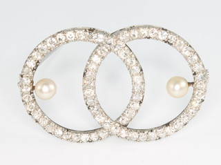A white gold diamond and pearl double ring brooch
