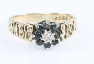 An 18ct yellow gold sapphire and diamond cluster ring size M