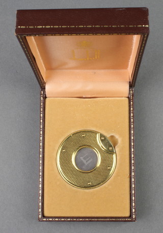 A gilt engine turned Dunhill cigar cutter, boxed 
