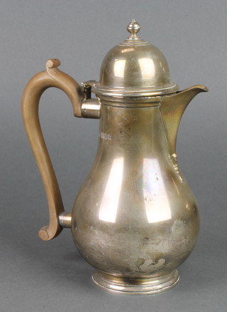 A silver bulbous coffee pot with high dome lid and fruit wood handle, London 1934, 658 grams gross