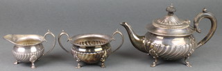 An Edwardian baluster silver 3 piece tea set with demi-fluted decoration and fruitwood handles, Sheffield 1902, gross 728 grams