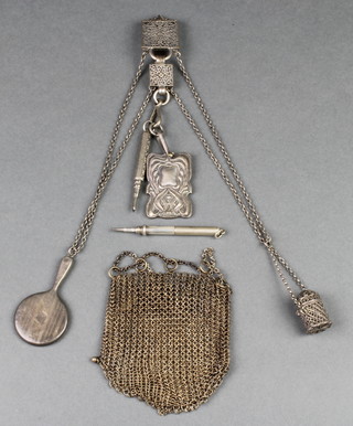 A miniature silver hand mirror, a chatelaine, mesh purse and pencil