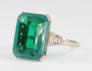 A white gold green paste and diamond ring, the brilliant cut emerald flanked by 5 ex 6 baguette cut diamonds, size M