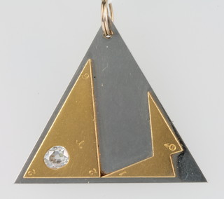 A triangular yellow gold and white metal pendant set a mine cut diamond 