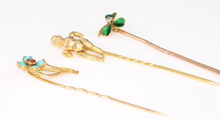 A 9ct yellow gold articulated figural tie pin, an enamelled and diamond ditto and a turquoise and gem set ditto 