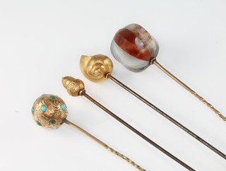 A yellow gold and hardstone hat pin, a turquoise set ditto, a gold chain and 2 gold hat pins 
