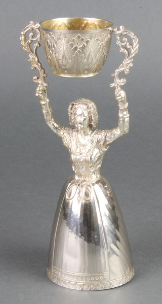 A silver wager/wedding cup in the form of a standing lady, the smaller cup with acanthus decoration London 1958, 8", 396 grams