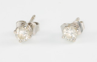 A pair of white gold single stone diamond ear studs, each 0.25ct 