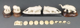 A pair of early 20th Century ivory figures of standing tigers 3", 3 carved ivory figures of standing elephants and an ivory buckle decorated with elephants 
