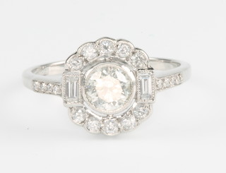 An 18ct white gold diamond cluster ring, the centre stone flanked by baguettes, approx. 0.9ct, size M 