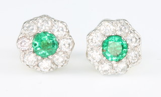 A pair of 18ct white gold emerald and diamond cluster ear studs 