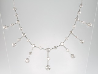 An 18ct white gold diamond drop necklace, comprising 31 graduated brilliant cut diamonds, approx. 6ct