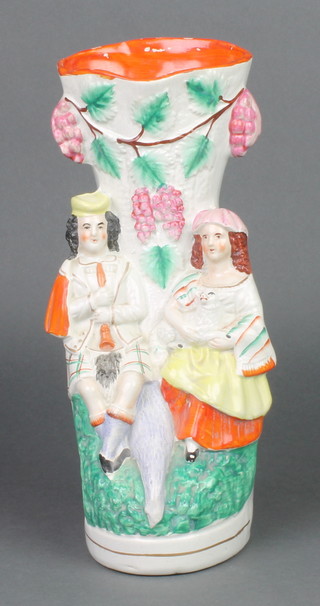 A Victorian Staffordshire spill vase in the form of a seated Scottish couple holding a lamb 12" 