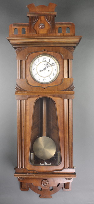 Gustav Becker, a Vienna style striking regulator with 7" circular enamelled dial having Arabic numerals and subsidiary second hand, contained in a carved walnut case 