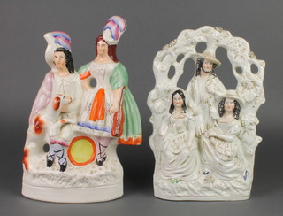 A Victorian Staffordshire group of a seated lady and gentleman with dog  13 1/2" together with a ditto of an arbour group with a gentleman and 2 ladies 12" 