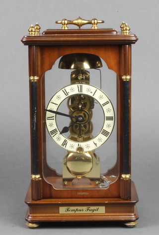 Widdop, a striking 4 glass clock with Roman numerals contained in a mahogany and glass case