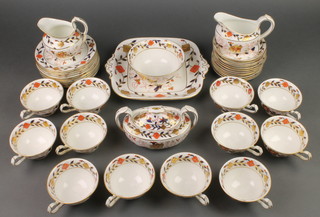 A Royal Crown Derby part tea set comprising 12 tea cups, 12 saucers, 12 small plates, 1 sandwich plate, cream jug, milk jug, sugar bowl and cover, slop bowl 
