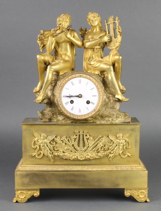 A 19th Century French 8 day striking mantel clock with paper dial and Roman numerals, contained in a gilt ormolu case surmounted by 2 figures of male and female classical musicians
