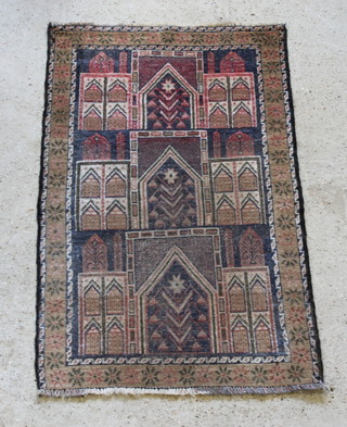 A Persian black and brown ground rug with panel decoration, some wear, 54" x 34" 
