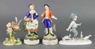 A Staffordshire figure of a robin 5", a pair of Bavarian figures of a lady and gentleman 7 1/2" and a figure group of a boy with geese 6" 