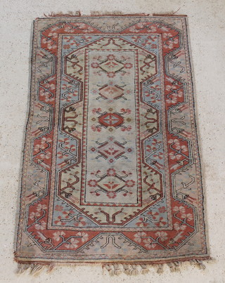 A Caucasian style rug with cream and tan ground 78" x 50", some wear and damage to the edge