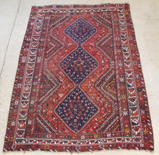 A Persian Qashqai carpet with 3 diamonds to the centre with blue and red ground 126" x 92 1/2", some light wear