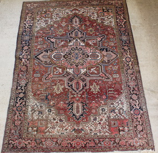 A Persian Heriz carpet with star design to the centre and tan ground, 146" x 103" 