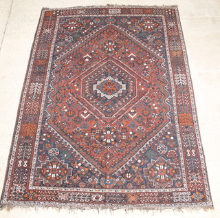 A Persian Qashqai red and blue ground rug with diamond shaped medallion to the centre 120" x 90" 