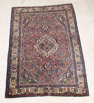 A Persian Tafresh red, green and blue ground rug with central medallion 81" x 58" 