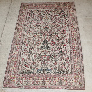 A Persian Kirman pink ground carpet decorated trees and animals 136" x 89" 