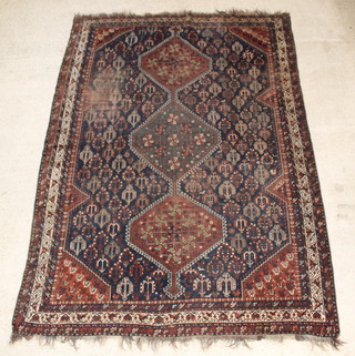 A Persian Qashqai blue ground carpet with 3 diamonds to the centre 122" x 87", in wear
