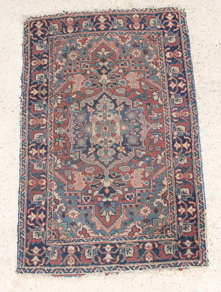 A Persian Toyserkan brown and blue ground rug with central medallion 53" x 34" 

