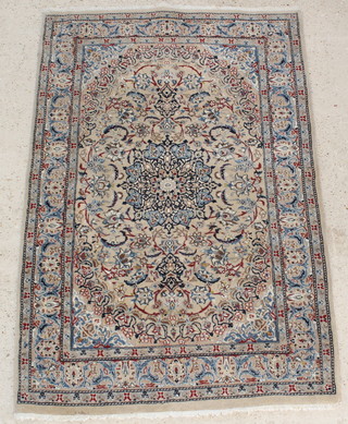 An Indo Persian white and blue ground rug with central medallions 78" x 52" 
